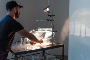 Alexander Rosenberg installs his work at the 2022 Intersection Exhibition, photo by: Natalie Tranelli Photography